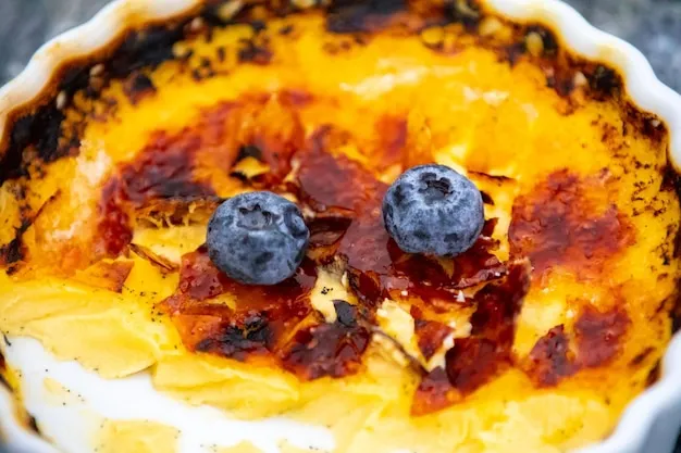 Crème brûlée featuring torched sugar crust and berries.