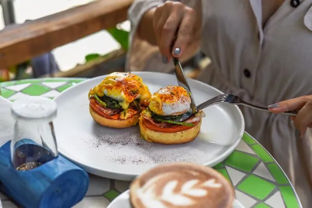 Cafe Bea team members presenting colorful brunch plates to guests in a sunny, welcoming dining space.