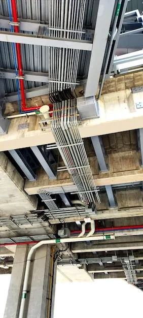 New plumbing and ventilation pipes being installed in apartment structure.