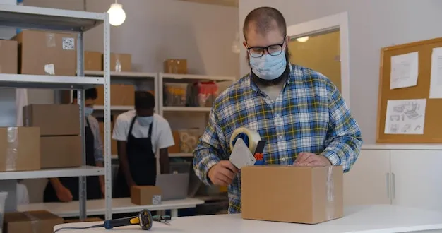 UPS Store associates packing a customer package securely with bubble wrap and boxes.