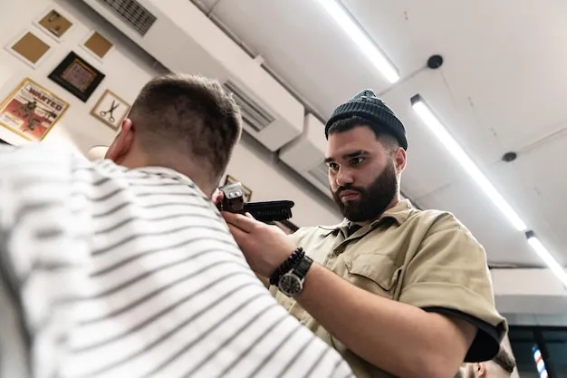 Barber styling a man's hair with a sharp fade and textured top.
