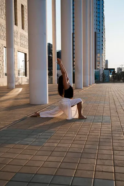 Group of yogis practicing vinyasa yoga in a bright, modern studio with large windows showing Miami skyline.
