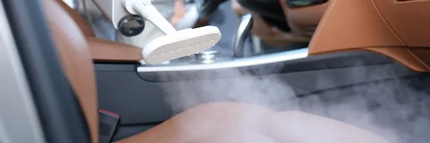 Steam cleaning upholstery inside a vehicle cabin.