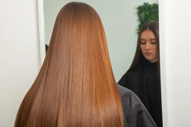 Client receiving keratin smoothing treatment on straight hair in salon.