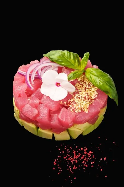 Vibrant tuna tartare with avocado mousse and microgreens.