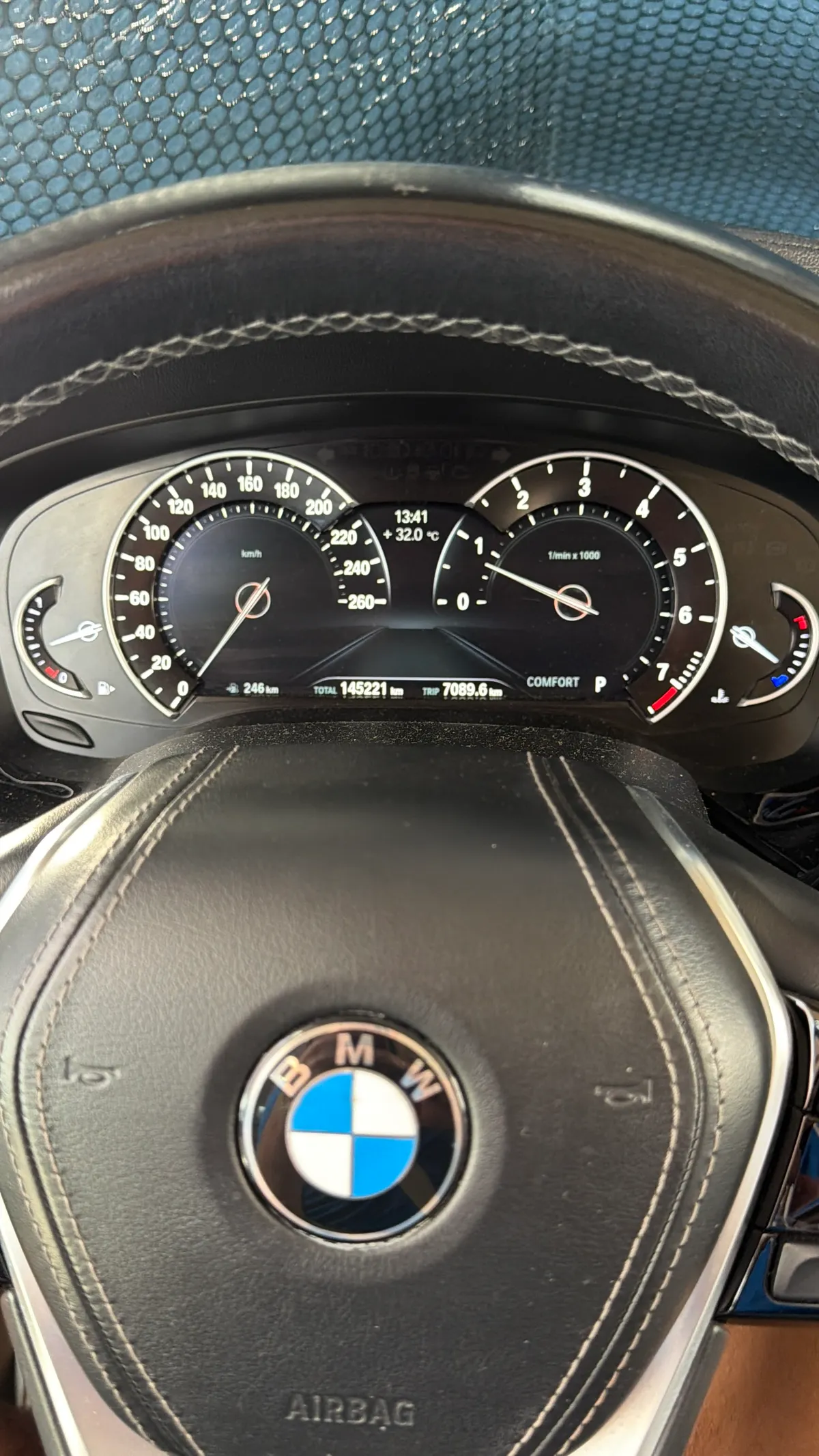 BMW instrument cluster showing a total mileage of 145,221 kilometres