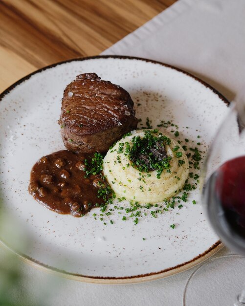 Sliced wagyu tenderloin with truffle mash and jus.