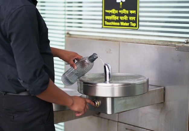Plumber servicing a grease trap under a commercial sink.