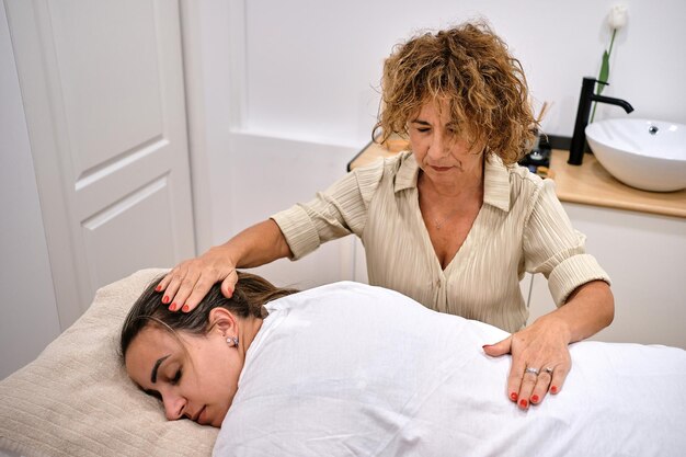 Client relaxing during scalp treatment massage.