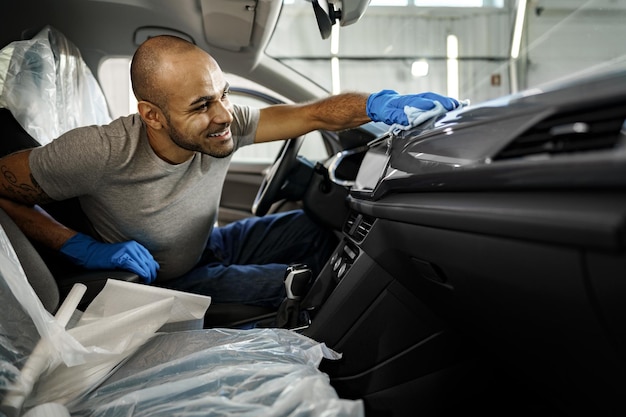Team of professionals detailing a luxury car interior at KOKO CAR WASH in Bétera.
