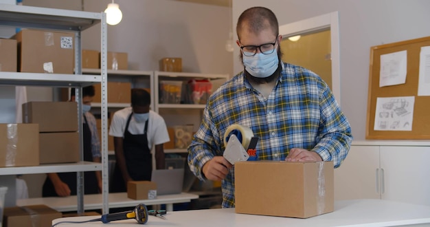 UPS Store associates packing a customer package securely with bubble wrap and boxes.