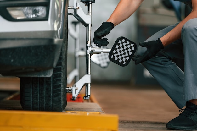 Wheel alignment setup on a car in professional garage.