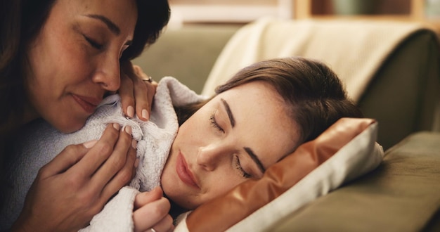 Therapist massaging cheeks and forehead on a relaxed client's face.
