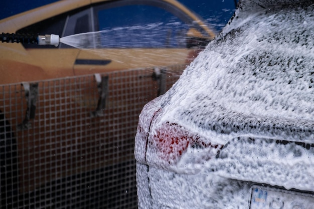 Vehicle enveloped in rich foam for premium exterior cleaning.