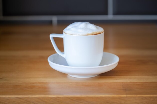 Rich cafe con leche in a white ceramic cup.