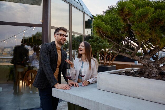 Business professionals mingling at an outdoor resort conference with ocean backdrop.