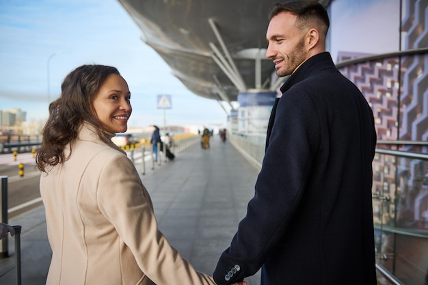 Uniformed staff smiling and directing passengers at Port Miami.