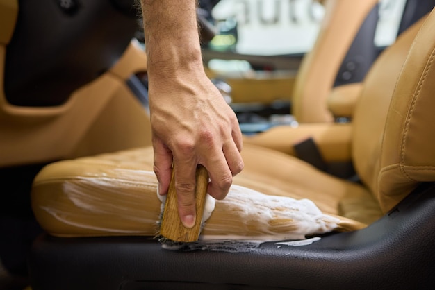Leather seats receiving conditioning treatment during interior clean.
