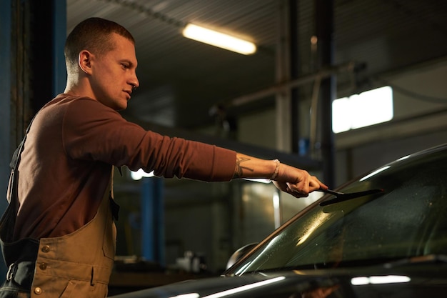 Window tint film being installed on automobile side windows.
