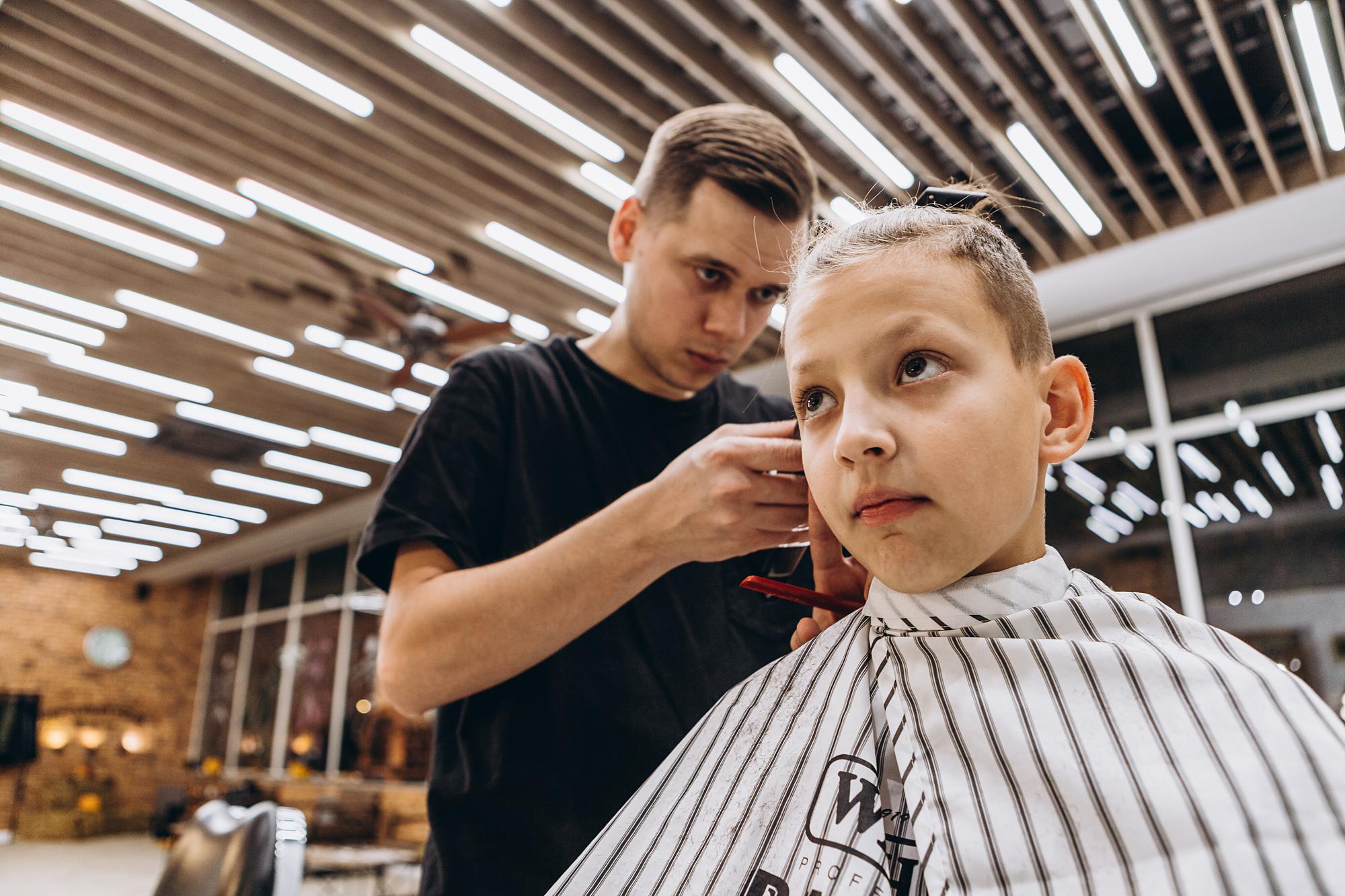 Child receiving a calm and careful haircut.