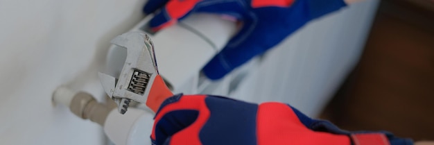 Plumber inspecting wall for leak with detection equipment.