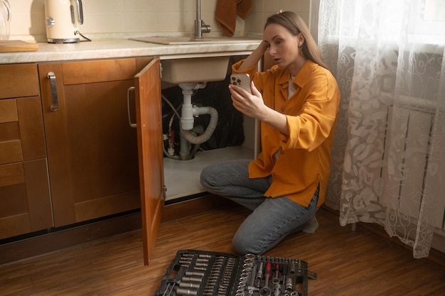 Technician operating drain cleaning equipment in a bathroom.