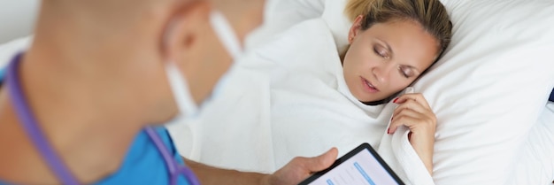 Wellness consultant guiding client on sleep hygiene with charts.