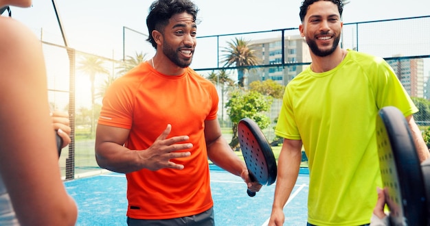 Team of padel enthusiasts celebrating on court at Real Padel Miami club.