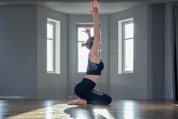 Close-up of yogi transitioning in vinyasa flow during Power 60 class.