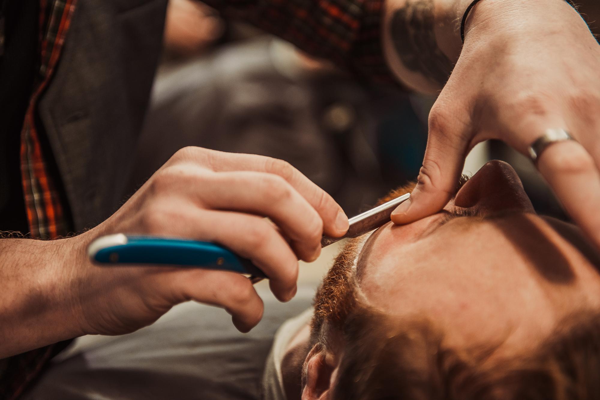 Detailed beard trim service in progress.