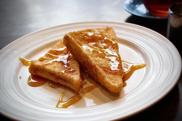 Towering French toast slices with fresh fruit and syrup drizzle.