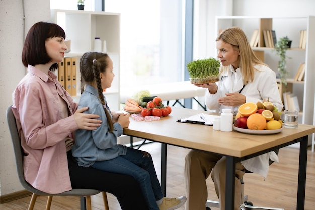 Family discussing nutrition plan with wellness expert in cozy setting.