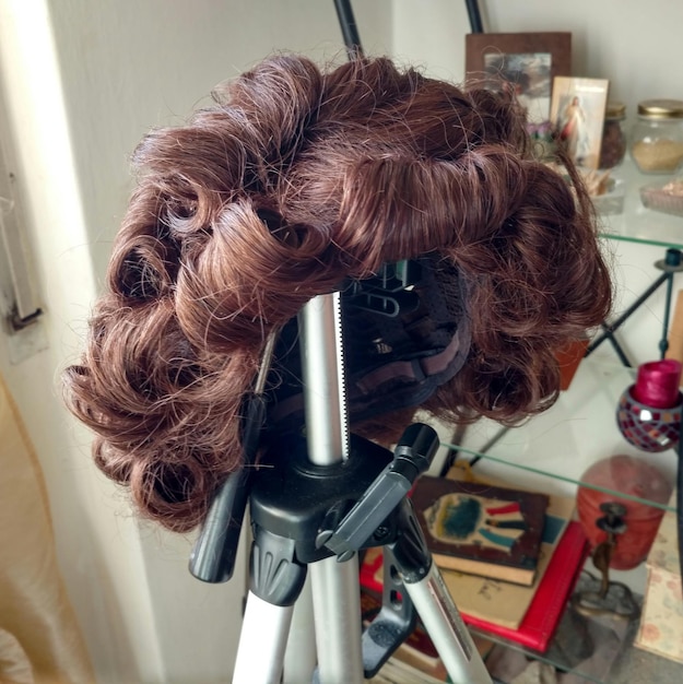 Stylist shaping and styling client's curly hair for volume.