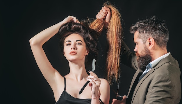 Professional styling session creating a voluminous, shiny hairstyle.