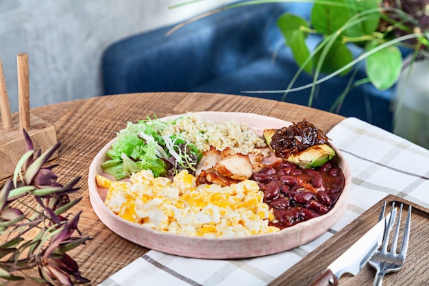 Hearty Nicaraguan rice porridge topped with steak and mixed vegetables.