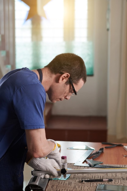 Skilled worker in workwear repairing an apartment interior, surrounded by tools and fresh materials.