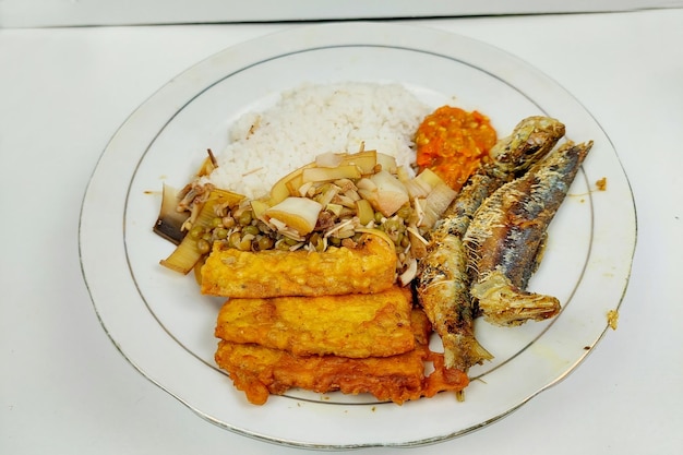 Golden fried fish accompanied by traditional sides.