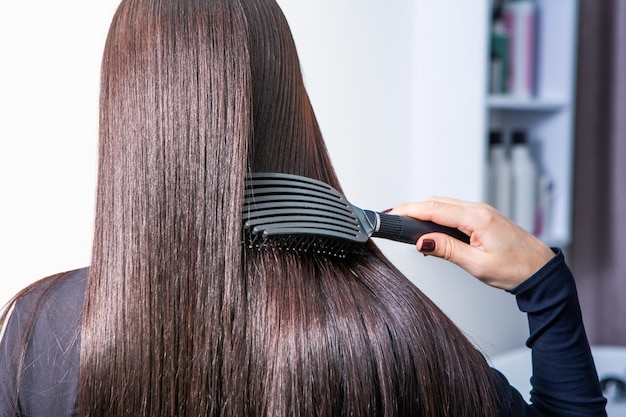 Keratin smoothing treatment being applied to client's hair.