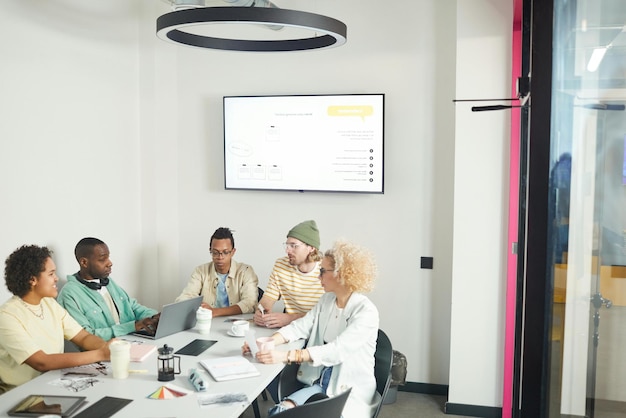 Intimate meeting room setup with tables, chairs, and collaboration tools for research workshops.