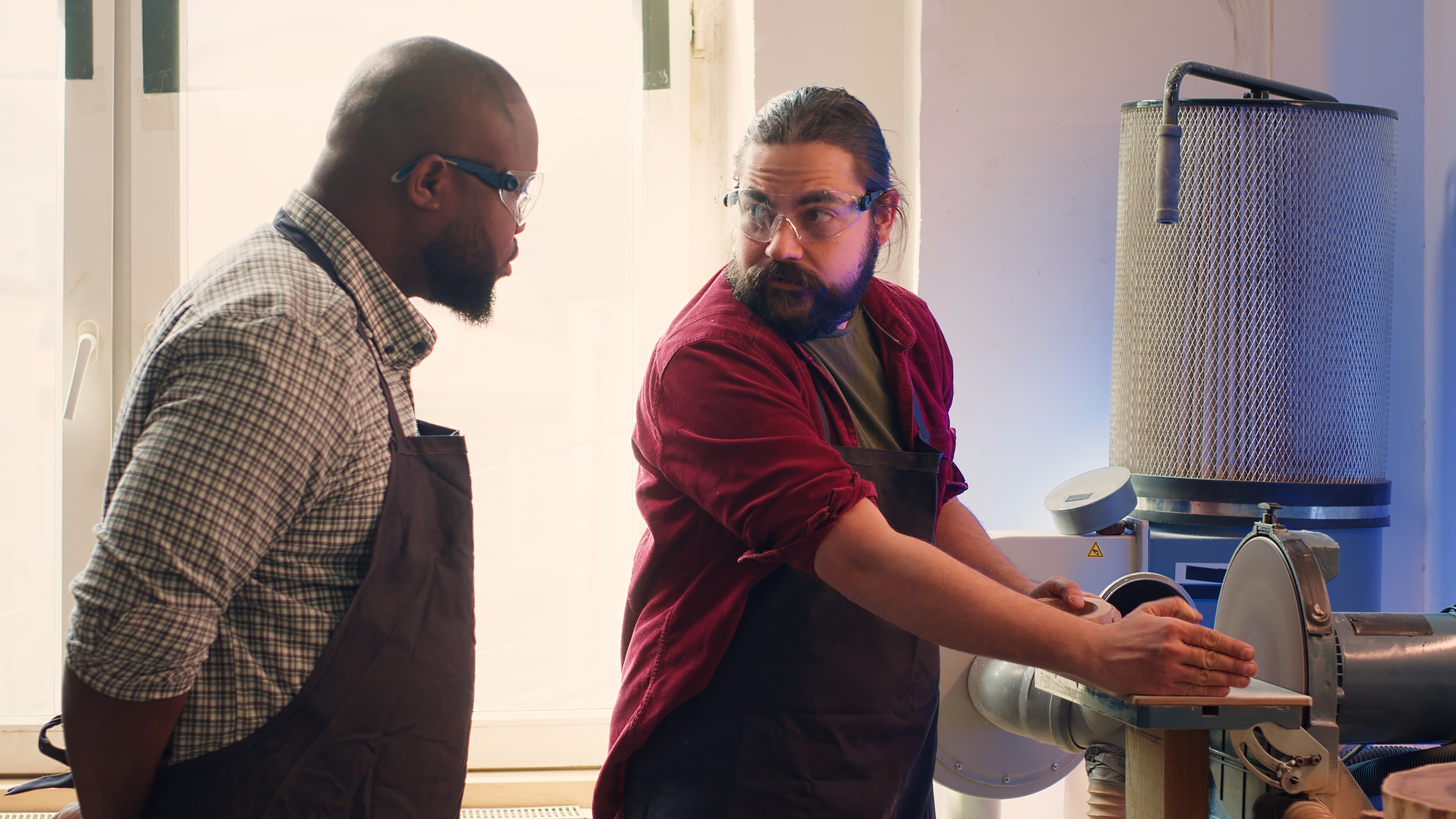 Team of uniformed plumbers reviewing plumbing plans at a job site.
