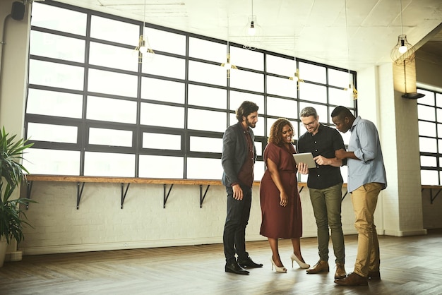 Event support staff arranging tables, chairs, and signage in a venue.