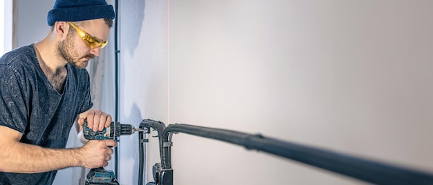 Plumber cutting and fitting new pipes in a home utility area.