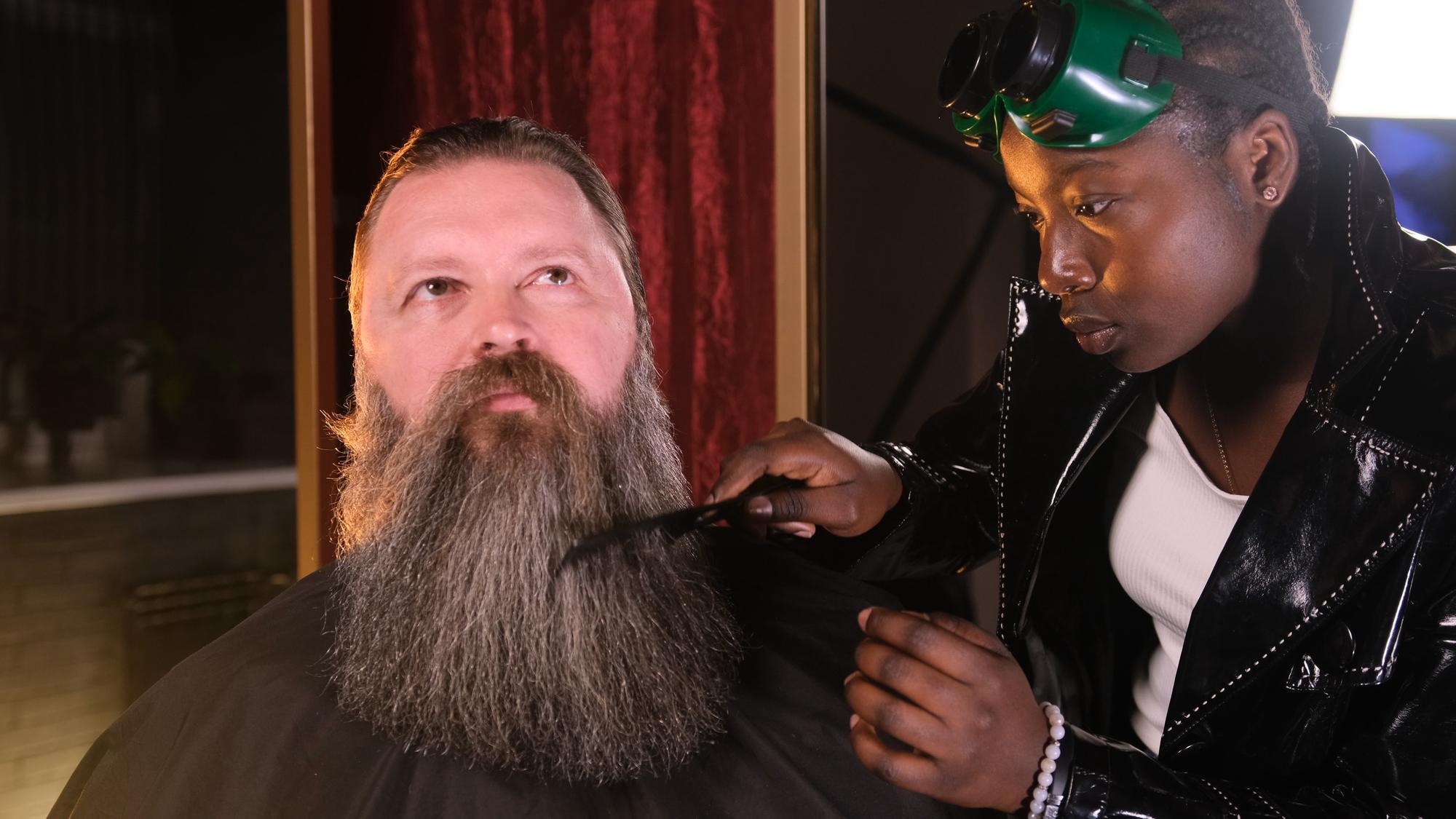 Client receiving a professional buzz cut from a barber with precision tools.