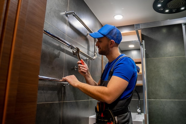 Plumber fitting new fixtures in a commercial restroom.