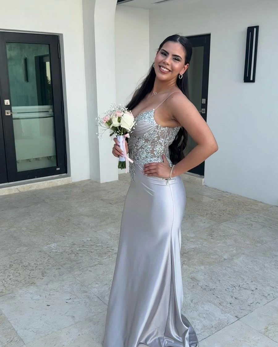 Girl in silver prom dress with bouquet