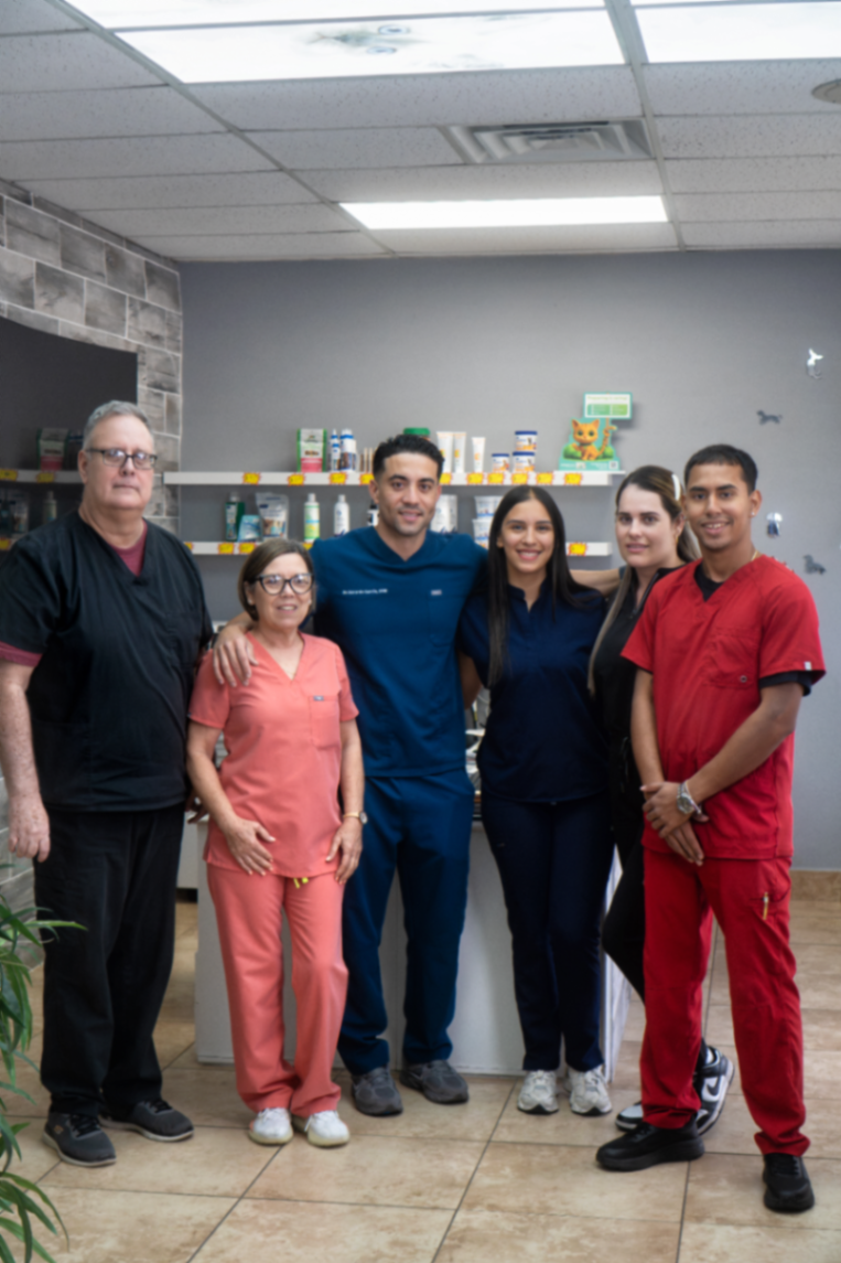 A group photo of the Miller Pets Animal
Hospital team, including Dr. Garcia and Karla Rosario, standing together in
their clinic.
